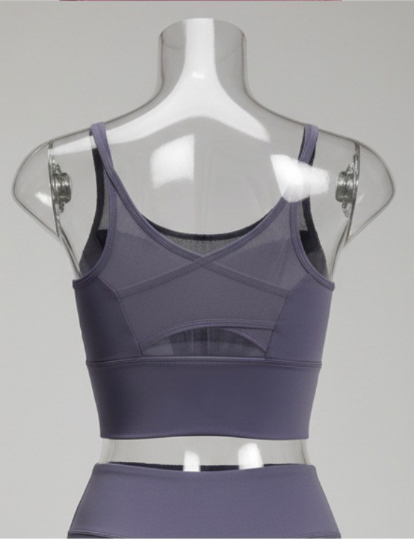 Purple sports bra on a mannequin against a gray background