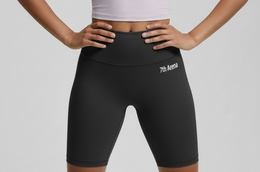 Person wearing black athletic shorts with '7th Arena' logo on a gray background