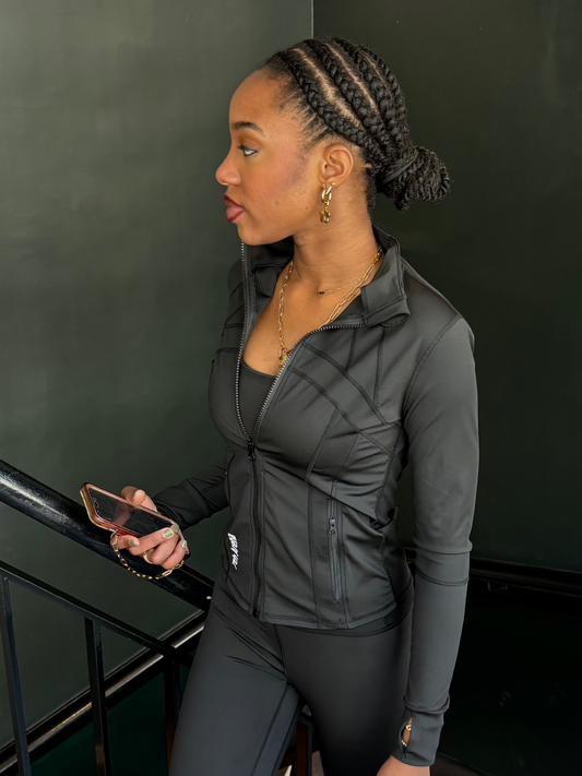 Woman in black athletic wear standing on a staircase 